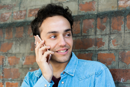 Latin man talking on the phone