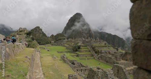 Handheld push in shot framing a mountain peak in the ruins of Machu Picchu in Peru photo