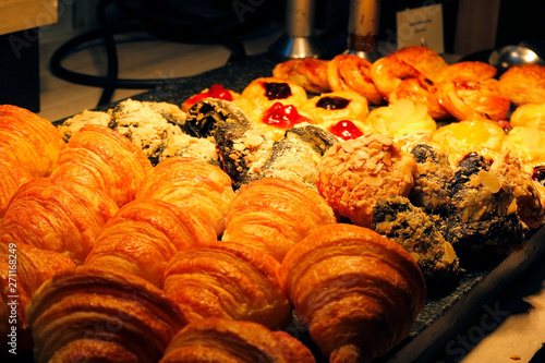 croissant bread, cinnamon roll and fruit danish dessert on buffet line