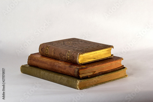 Slika na platnu Stack of Three Antique books on a white background.