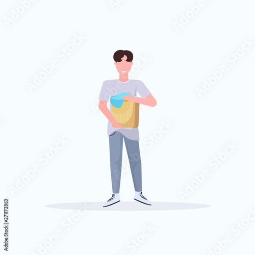 man holding basket with dirty clothes guy doing housework concept male cartoon character full length flat white background