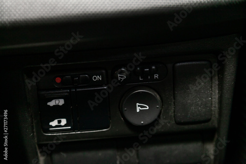 Interior design of the modern car: : side mirror adjustment, off road buttons. luxury prestige car interior. © Виталий Сова
