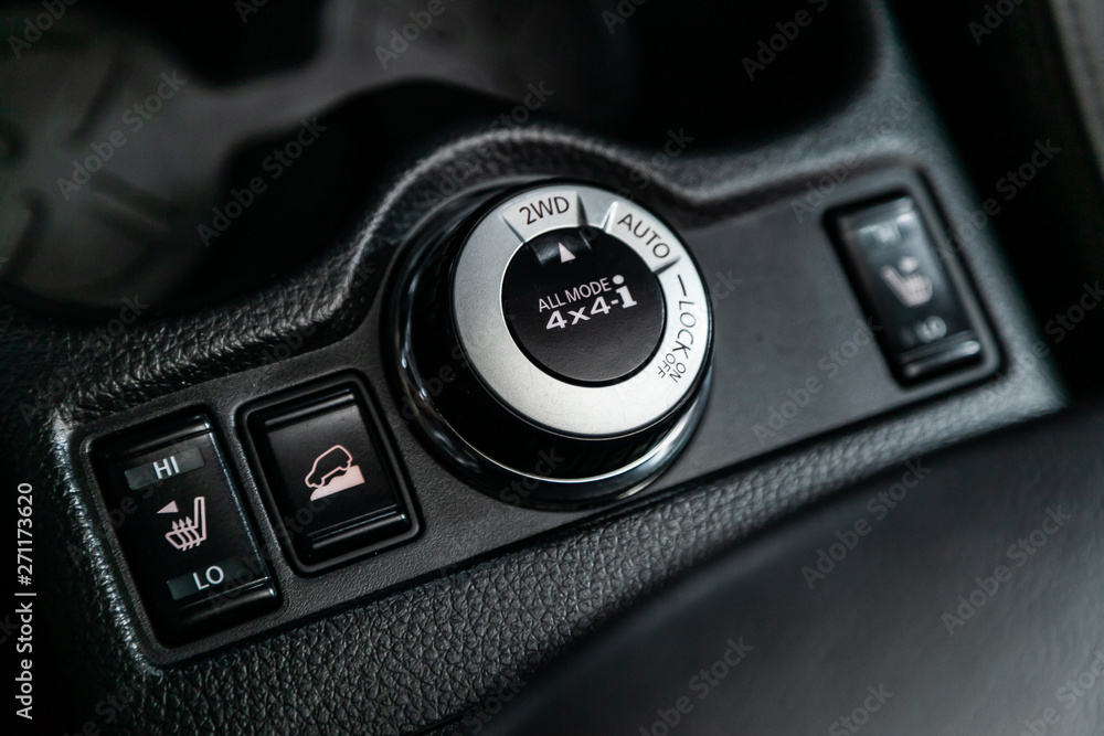 Сlose-up of the car  black interior:  dashboard, seat and heating buttons, off road, assistance during the descent from the mountain and other buttons