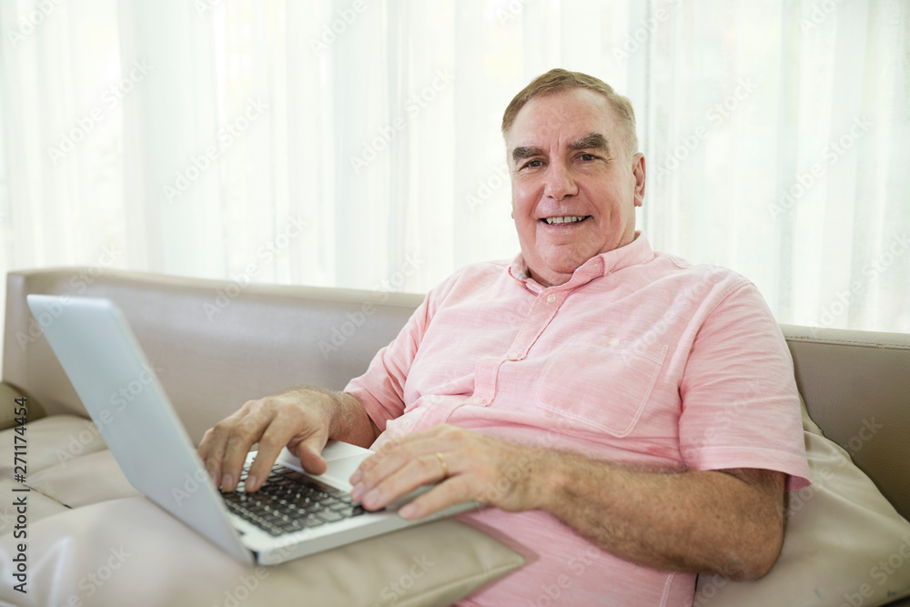 Happy senior man enjoyng playing game on laptop at home Happy senior man enjoyng playing game on laptop at home