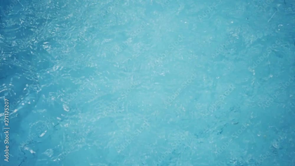 slow motion, water splashing drop in blue swimming pool slow motion, water splashing drop in blue swimming pool