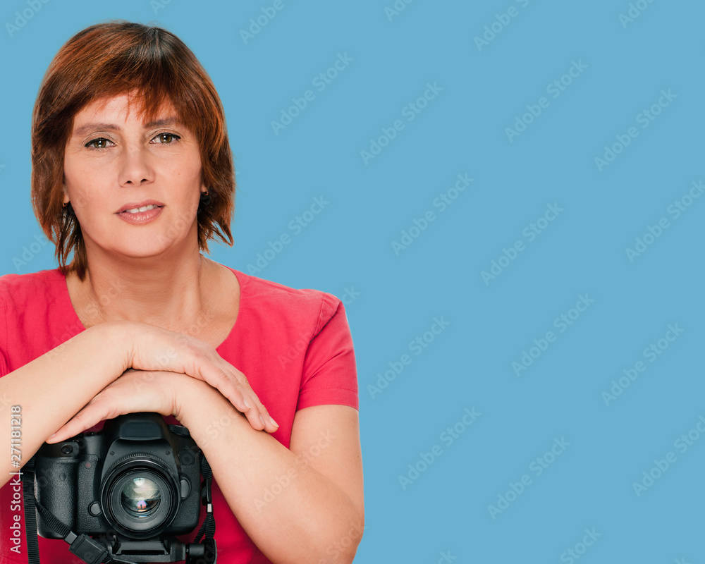 Fototapeta premium portrait of senior woman with camera on blue color background
