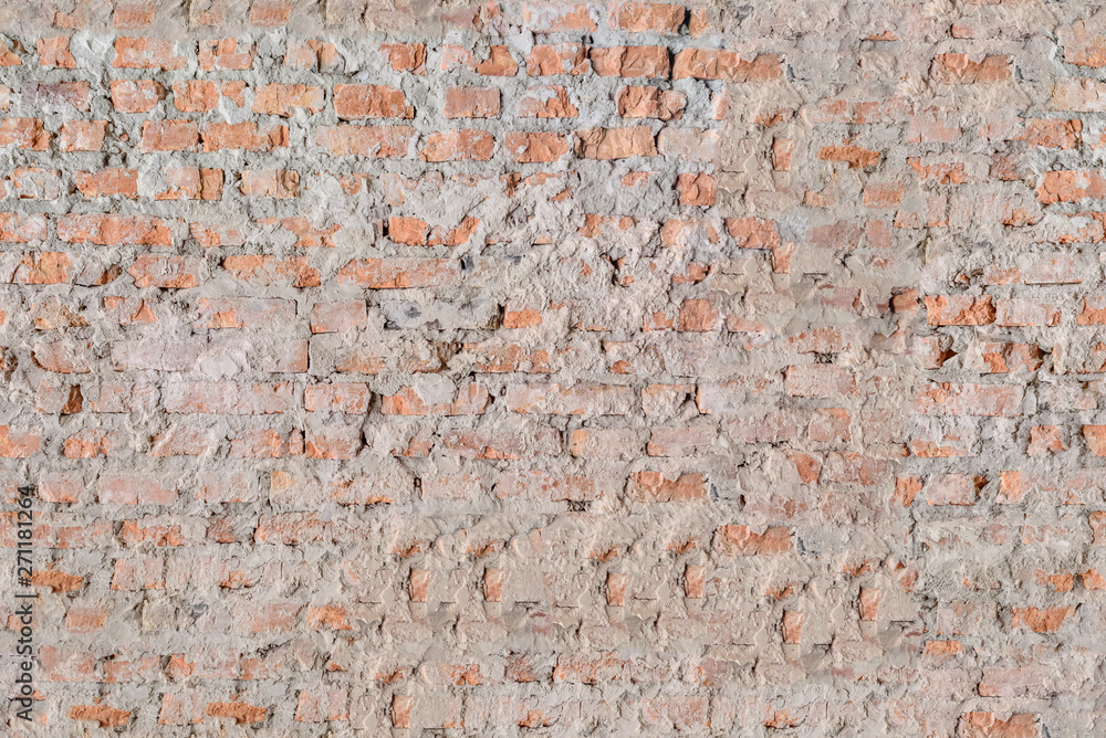 Closeup of old cracked red stone wall background, seamless tiling texture Closeup of old cracked red stone wall background, seamless tiling texture