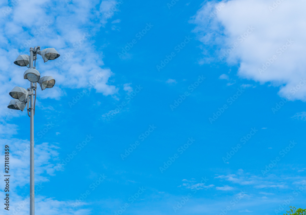 Spotlight on lighting tower Clound Blue sky background