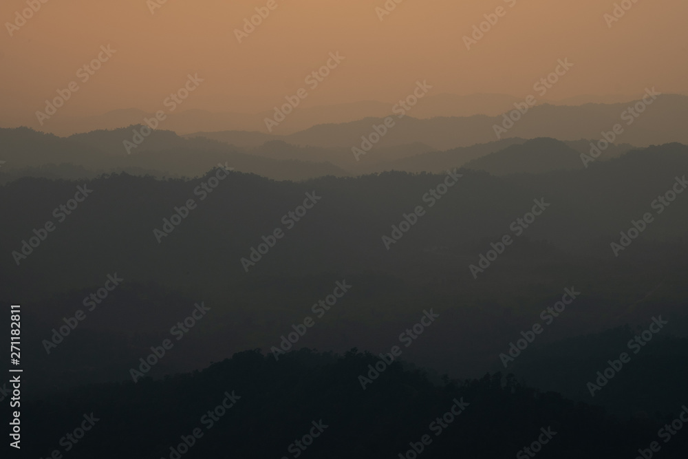 landscape fantastic sunset on foggy autumn forest valley, mystical valley background