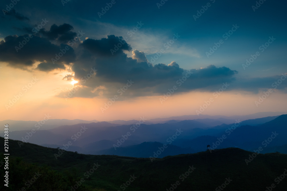 landscape fantastic sunset on foggy autumn forest valley, mystical valley background, blue colors