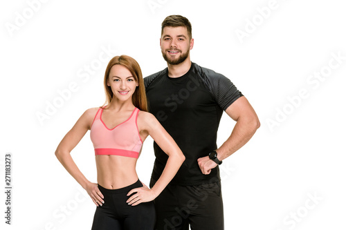 Fit bodybuilding couple posing together on white background