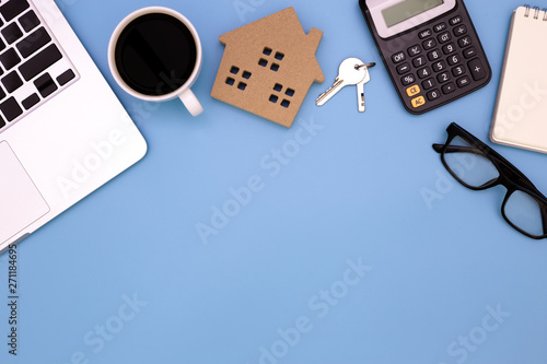 flat lay Office desk table of modern workplace with laptop on blue table, top view laptop background and home wooden, blue desk office with laptop, home sale office desk concept,