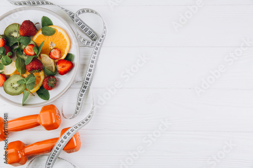 Fotografie Diet plan, menu or program, tape measure, water, dumbbells and diet food of fres