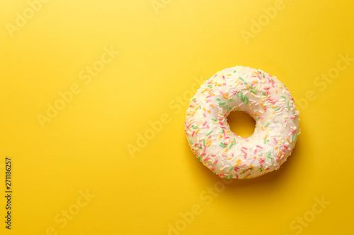 white donut on yellow background top view copy space