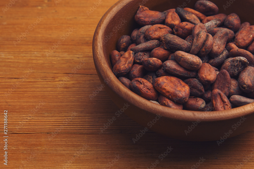Cocoa beans on old wooden table Cocoa beans on old wooden table