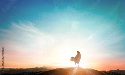 World environment day concept: Silhouette rooster on blurred beautiful mountain autumn sunrise sky background