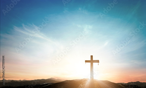 Canvastavla Silhouette of Christian cross on a hill at sunrise with soft lens flare and hope