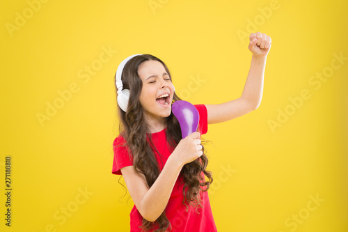 Sing lyrics. Child teen enjoy music playing in earphones. Little girl enjoying favorite music. Catch the rhythm. Kid listening music headphones. Entertainment and fun. Whole musical world in her ears