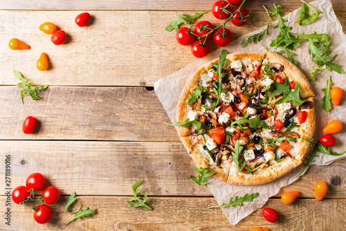 Vegetable italian pizza with tomatos on wodeen background