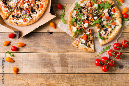 Vegetable italian pizza with tomatos on wodeen background photo