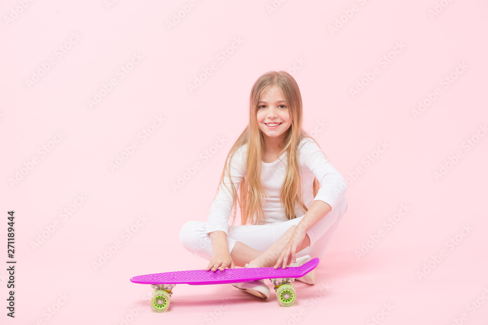 Active lifestyle. Girl having fun with penny board pink background. Kid adorable child long hair adore ride penny board. Happy childhood. Ride penny board and do tricks. Girl likes to ride skateboard Active lifestyle. Girl having fun with penny board pink background. Kid adorable child long hair adore ride penny board. Happy childhood. Ride penny board and do tricks. Girl likes to ride skateboard