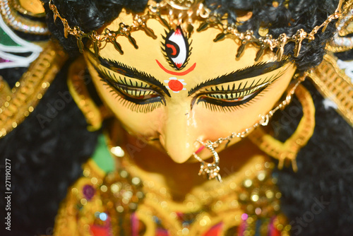Close up of Durga Maa with a third eye or "TriNayani". A symbol of strength and power. Portrait photography captured from a famous potter studio in Kumartuli, Calcutta Kolkata, West Bengal, India.