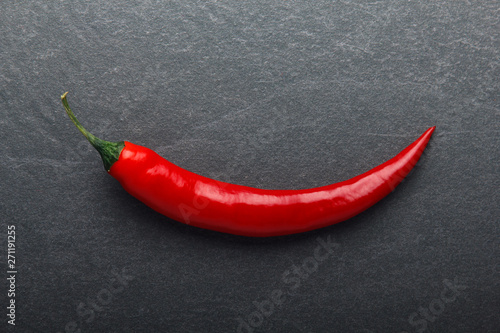 Red chili pepper on black background