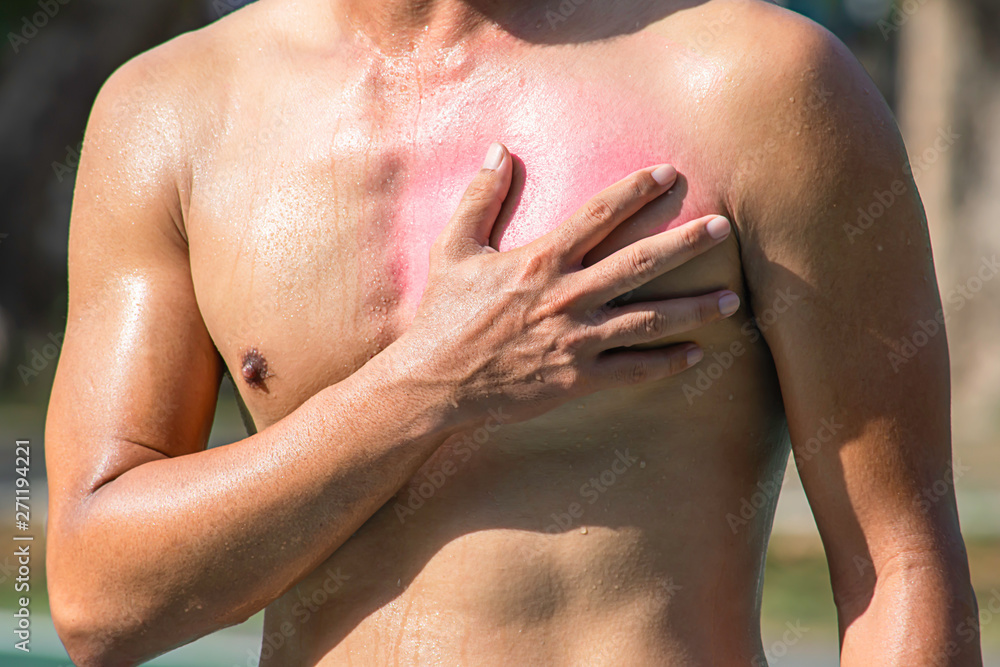 Naklejka premium The hand grips the chest that inflammation from a sports injury.