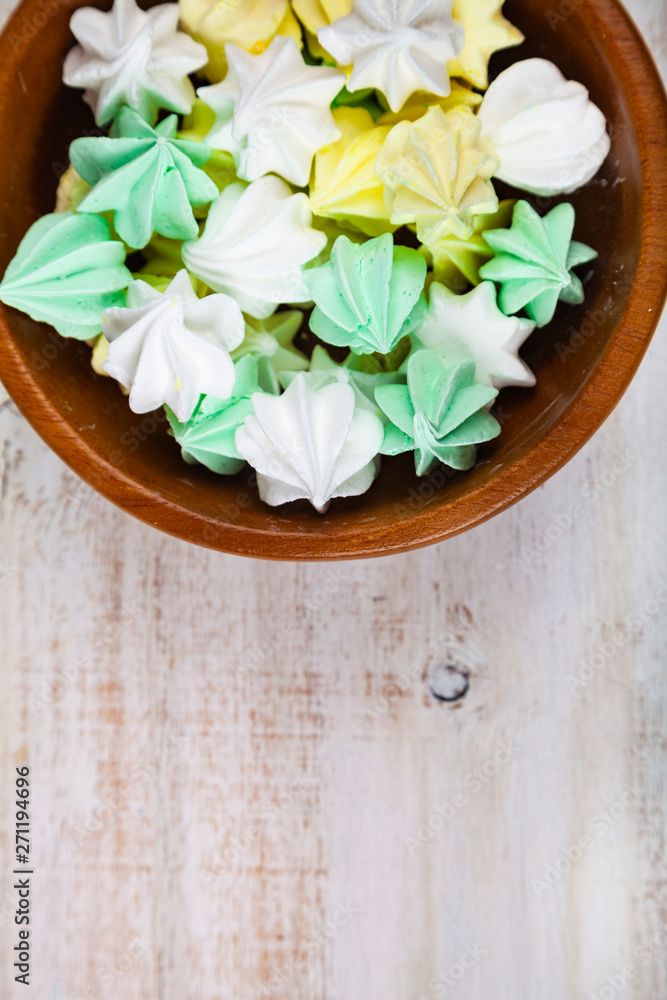Meringue in white bowl on a wooden background Meringue in white bowl on a wooden background