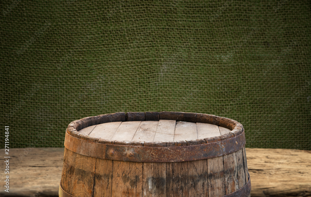 Wooden barrel on a table and textured background