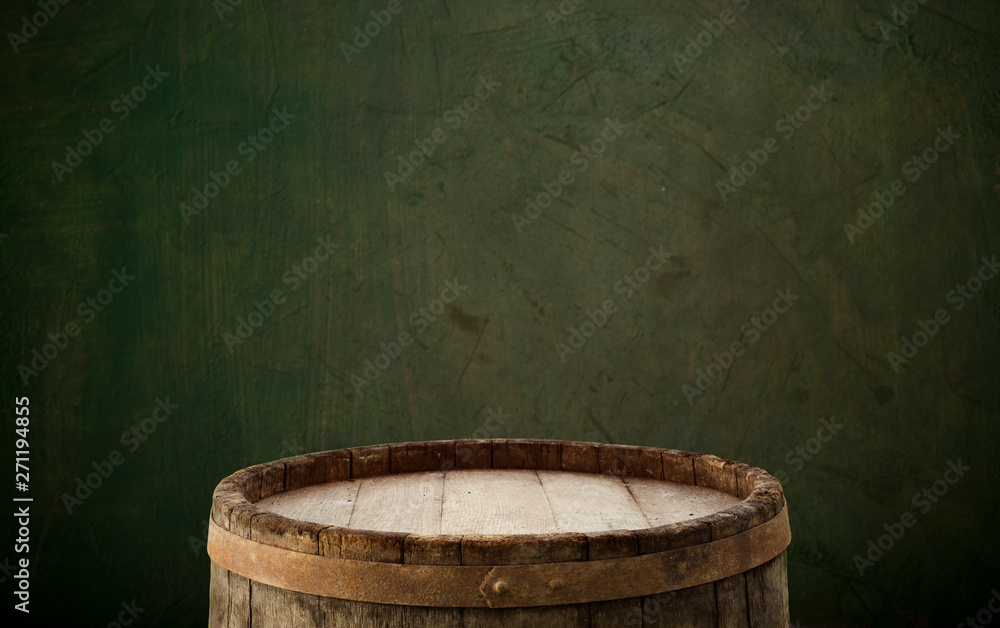 Fototapeta premium Wooden barrel on a table and textured background