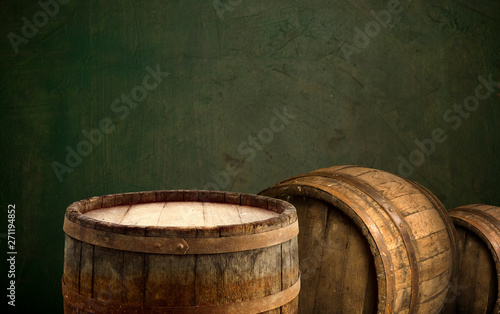 Wooden barrel on a table and textured background © kishivan