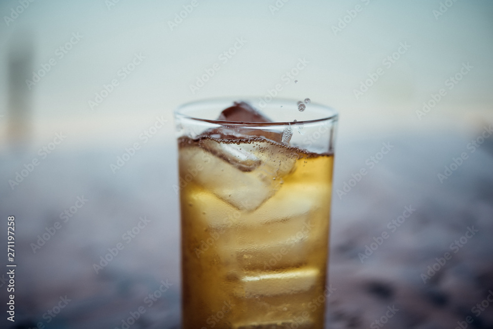 Fresh beer water in to glass with ice and froth Fresh beer water in to glass with ice and froth