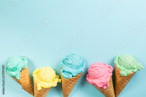 Canvas Print Pastel ice cream in waffle cones, bright background, copy space