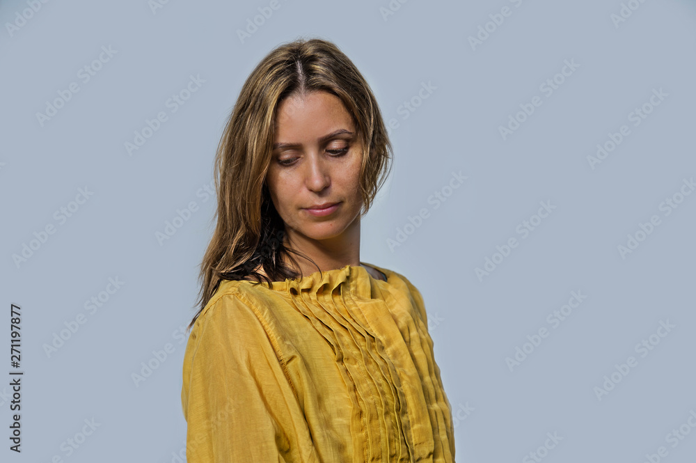 Young attractive and beautiful professional model woman posing wearing sweet yellow dress in beauty and fashion design concept Young attractive and beautiful professional model woman posing wearing sweet yellow dress in beauty and fashion design concept