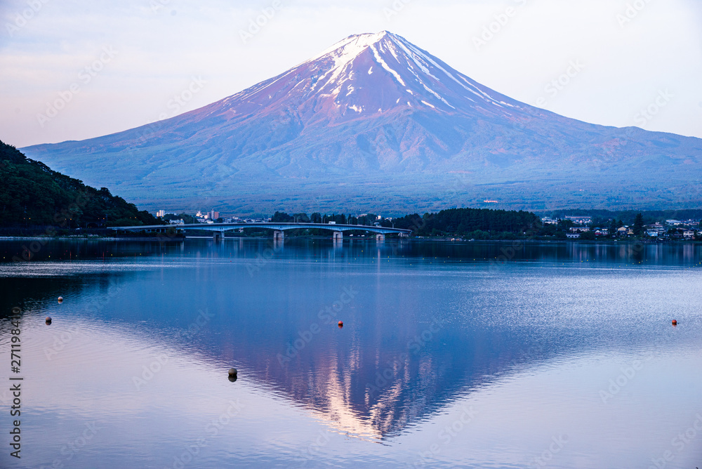 The reflection of beautiful Fuji mountain with bridge in lake  in the summer, the famous landmark and attraction place of tourists who have a long holiday in Japan, Lake Kawaguchiko