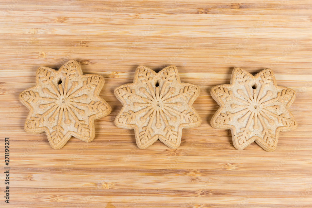 Cookies in form of stars in row on wooden surface Cookies in form of stars in row on wooden surface