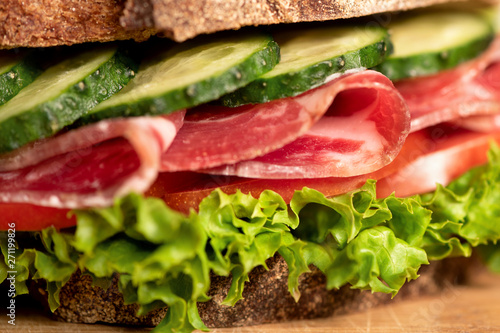 Sandwich with raw ham and vegetables.