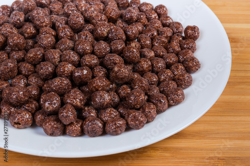 Breakfast cereal chocolate balls on dish close-up