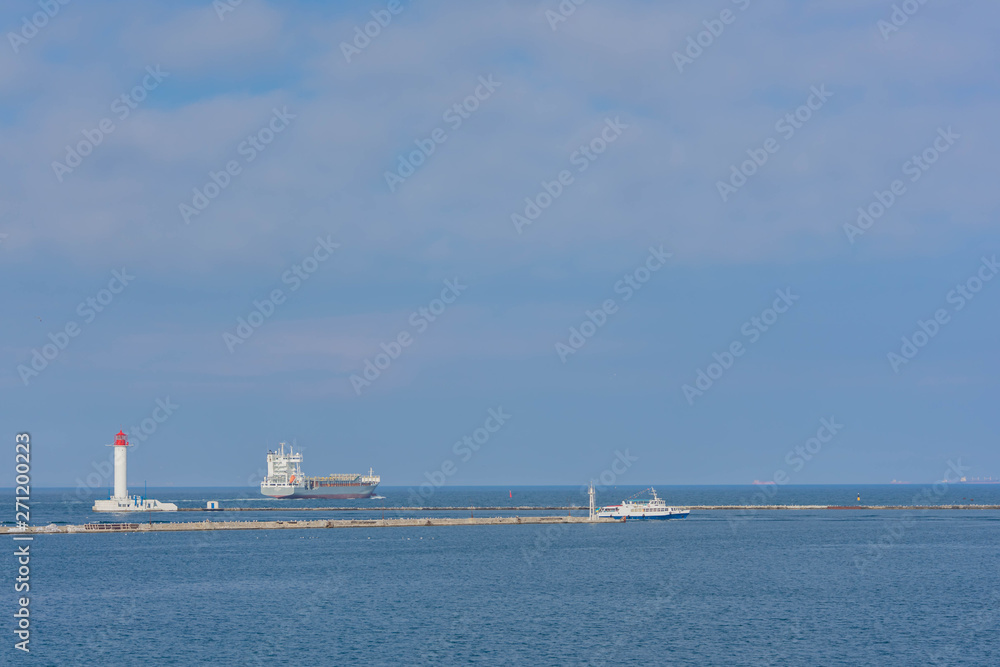Odessa Commercial Sea Port and Marine Station.Sea entrance to the port, yachts, cargo ships and lighthouse.