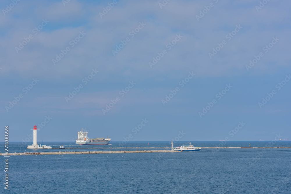Odessa Commercial Sea Port and Marine Station.Sea entrance to the port, yachts, cargo ships and lighthouse. Odessa Commercial Sea Port and Marine Station.Sea entrance to the port, yachts, cargo ships and lighthouse.