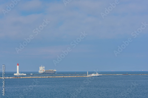 Odessa Commercial Sea Port and Marine Station.Sea entrance to the port, yachts, cargo ships and lighthouse.