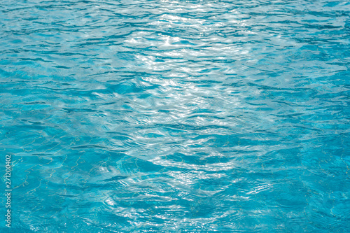 Beautiful sunny blue pool water background. Horizontal color photography.