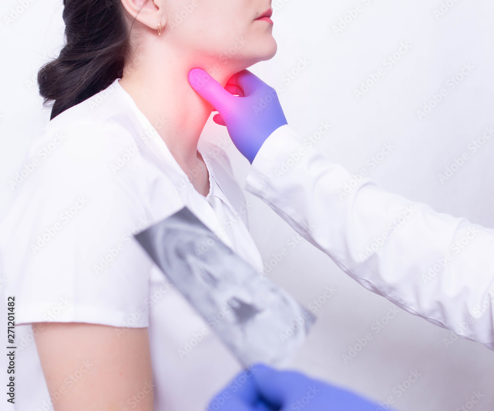 A specialist doctor diagnoses a girl s sore throat by palpating for the presence of inflammation and swelling, sore throat and tonsillitis of the throat A specialist doctor diagnoses a girl s sore throat by palpating for the presence of inflammation and swelling, sore throat and tonsillitis of the throat