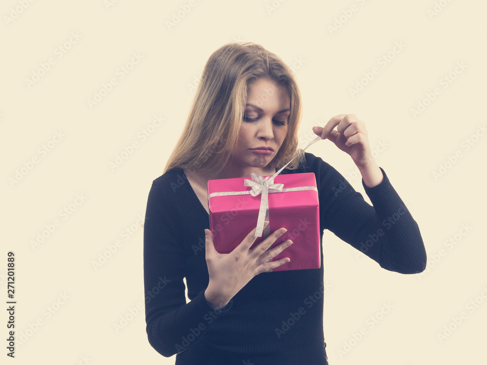 Girl opening pink gift box