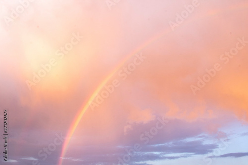 Bright beautiful rainbow on the background of coloured cloudy sry while sunset. Season, summer, phenomenon of nature © Татьяна Андрианова