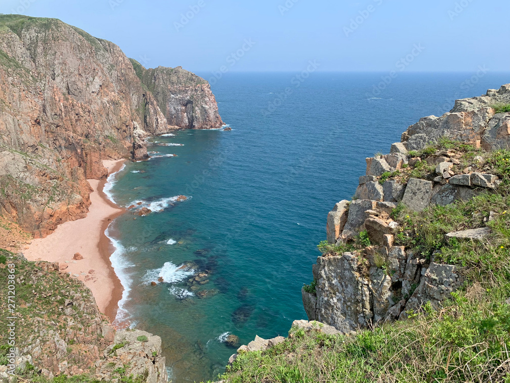 Fototapeta premium The rocky shore of the island of Shkot in spring. Russia, Vladivostok