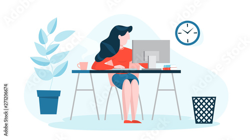 Woman in a suit sitting at the desk and working