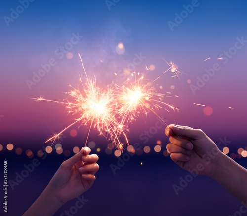 Couple holding a sparklers on the beach