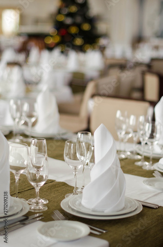 Shot of napkins and wine glasses banquet table at luxury restaurant